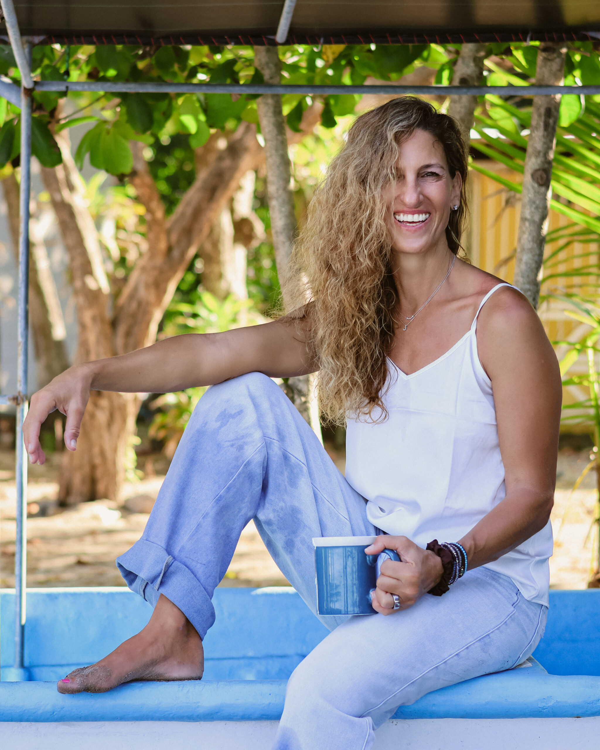 Jen Rulon laughing with a cup of coffee in Costa Rica